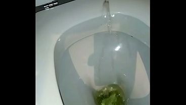 Cock urinating, wearing women's clothing and with painted nails.