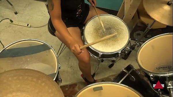 Playing drums in heels and shorts
