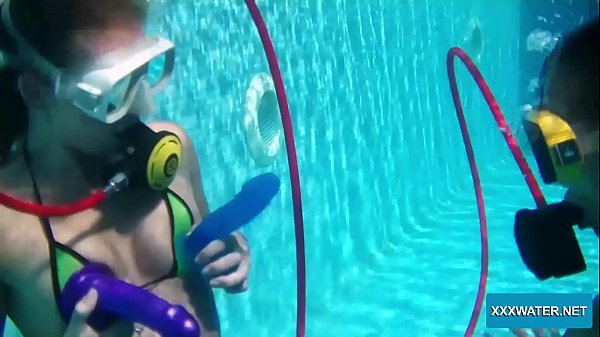 two lesbians underwater with dildo in pool
