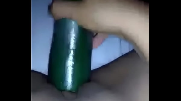 My wife using a cucumber