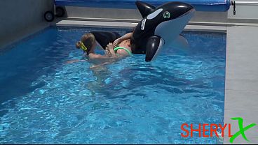 Two girls are having fun in the pool.