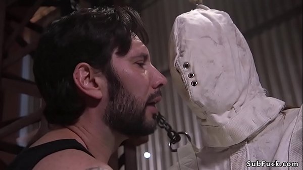 Slave in strait jacket and mask in bondage