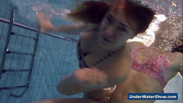 Horny girls strip eachother in the pool