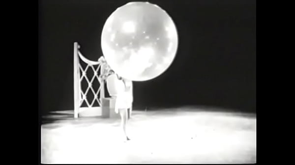 Vintage babe on stage with props doing strip routine