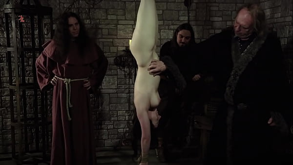 Mooin Witch – The exhausted milkmaid is pulled upside down to the ceiling with weights at her wrists  to be tormented and interrogated further and to see milk flowing (preview)