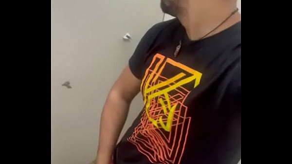 Jacking off, softening this thick cock from the torso to the head until he cums in the bar's bathroom