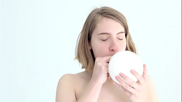 Young looner babe blowing and popping her first balloon