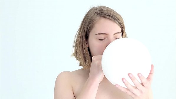 Young looner babe blowing and popping her first balloon