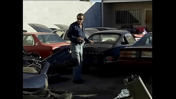 Sexy babe with small perky tits rides car mechanic's big cock on garage floor