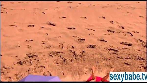 Tanned superbabe rubs herself on sandy beach