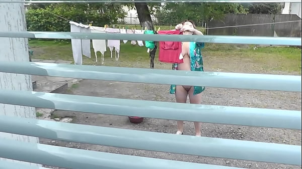 MILF naked in public. Frinas husband watches through window as a pregnant neighbor without panties and a bra dries clothes in courtyard of house. Voyeur. Peeping. Public nudity. Outdoors POV