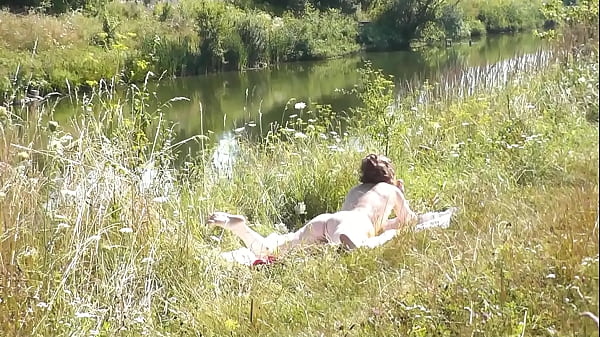 Nude Milf sunbathing on river bank. Random guy watching and filmed on his smartphone. Wild beach. Naked in public. Nudist beach. Doggystyle. Ass. Pussy. Doggy style. POV. Outdoor. Outside. Publicly. Ass milf. Butt. In nature. Without panties. No panties