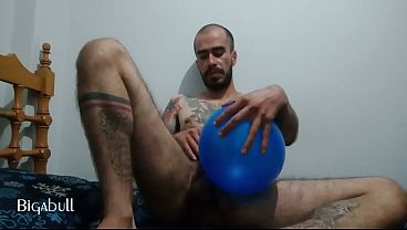 Hard cock sliding between inflated balloons
