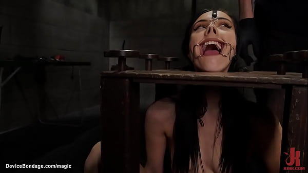 Bound beauty in bondage cube clamped